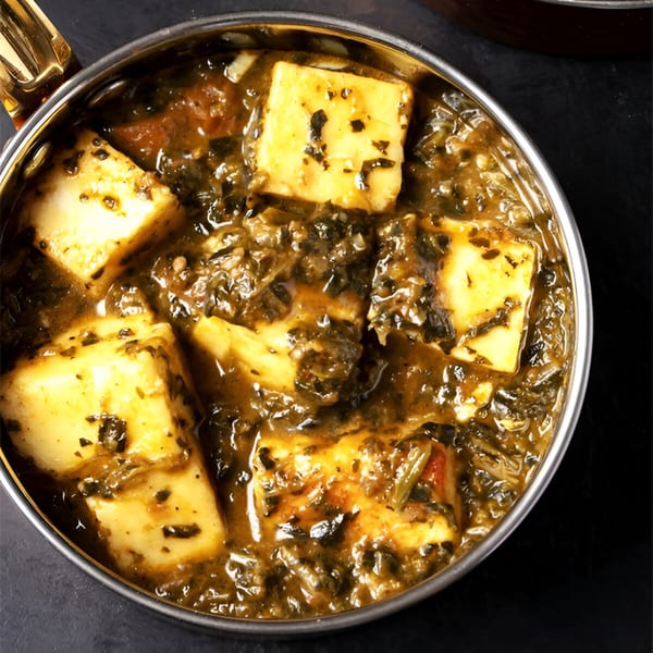 Close-up of Palak Paneer, an Indian dish with paneer cheese cubes in a spinach curry.
